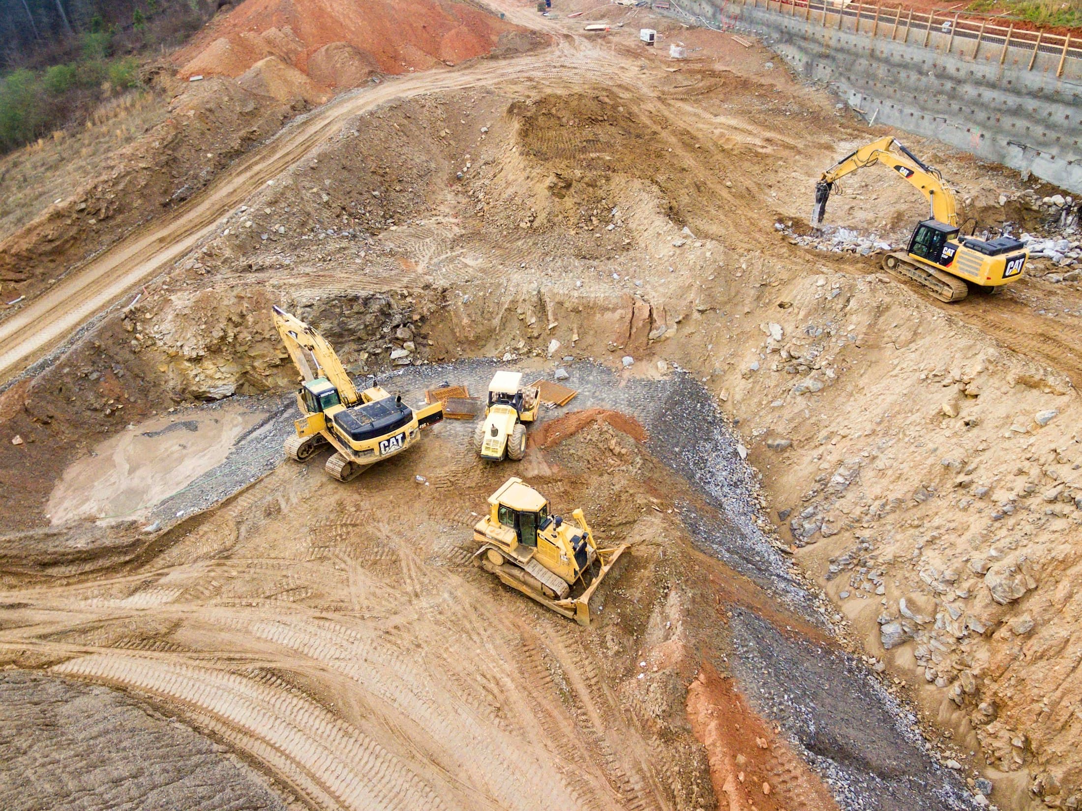 Aerial view of excavators and earthmoving equipment preparing a large site